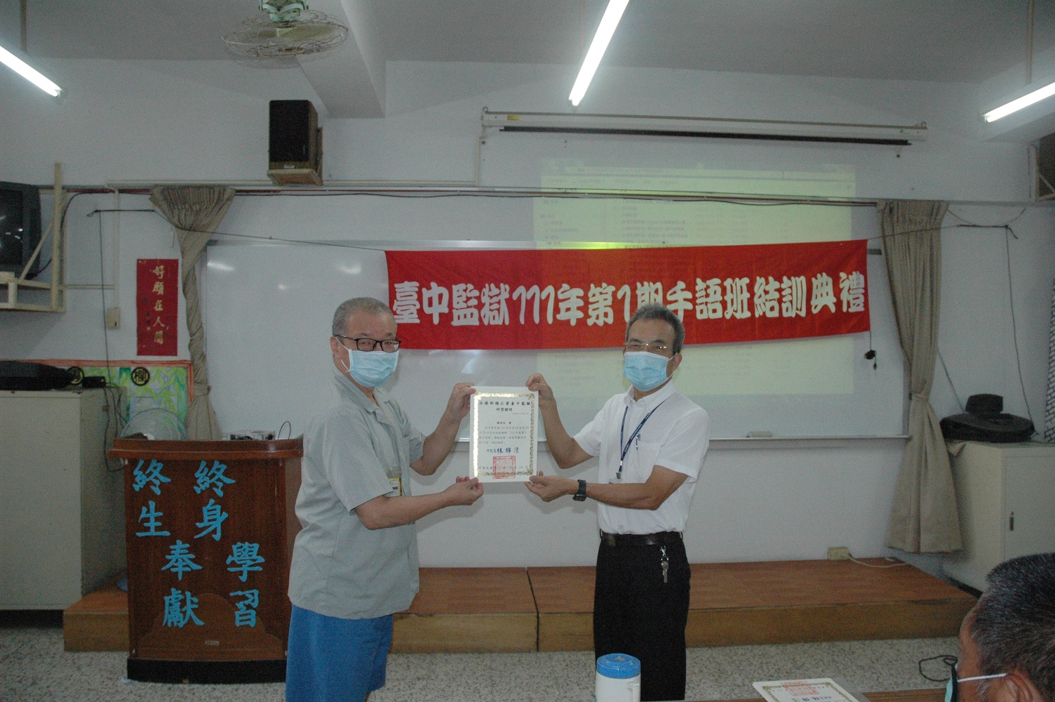 A sign language learner receives his certificate