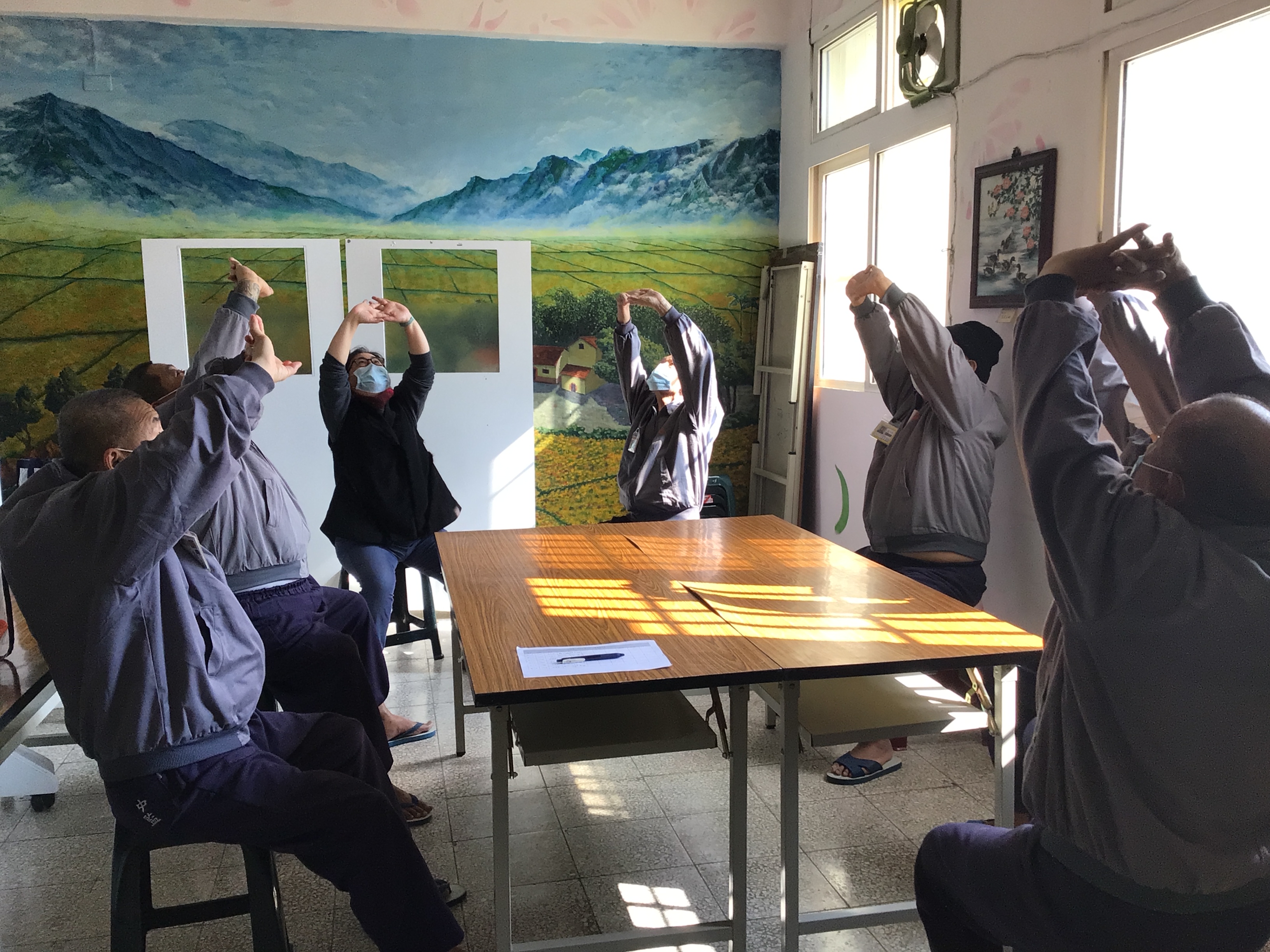 Participants warm themselves up with Baduanjin qigong exercise