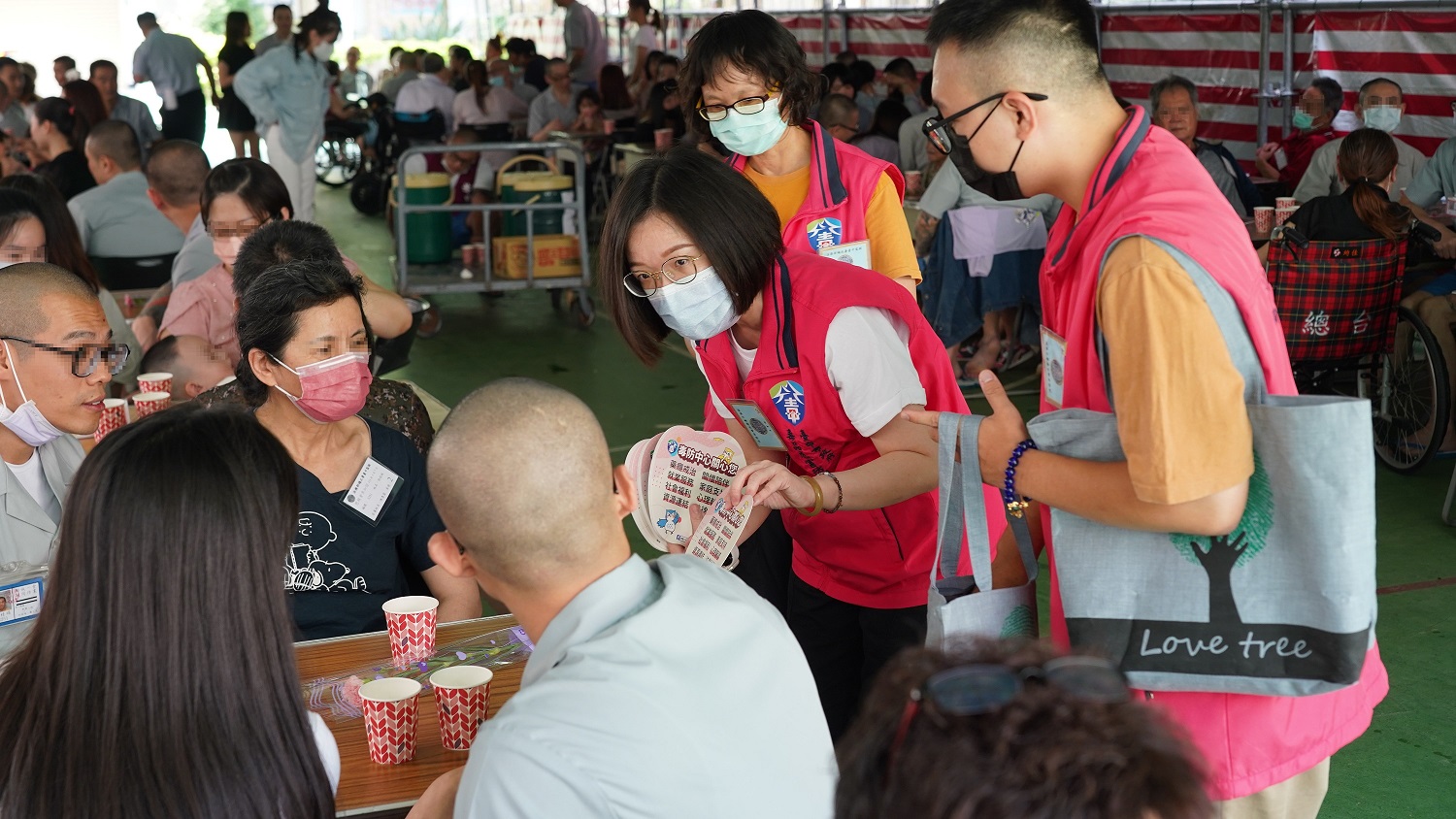 Volunteers distribute brochures about social care resources