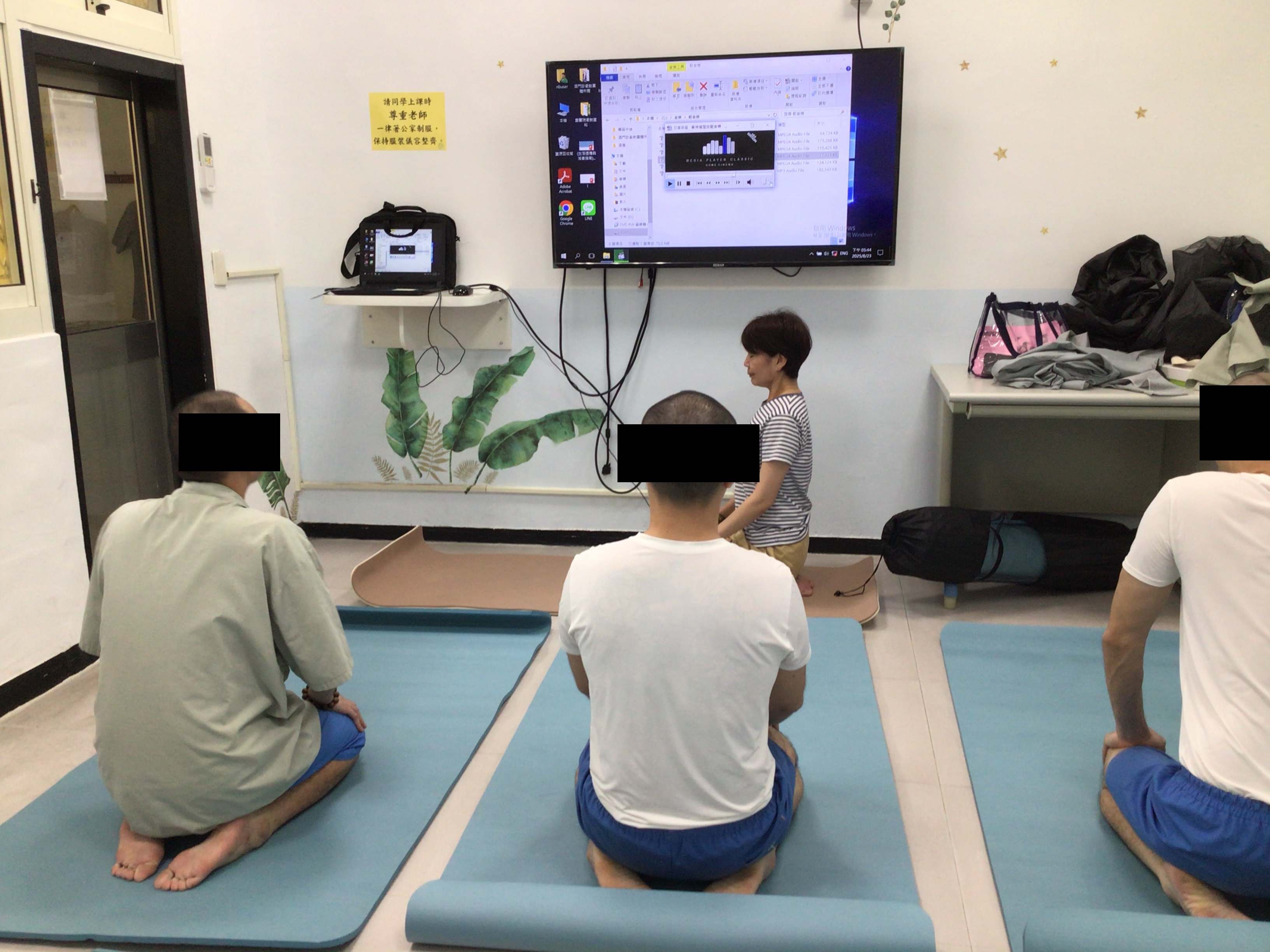 Inmates follow the instructor to practice yoga and meditation